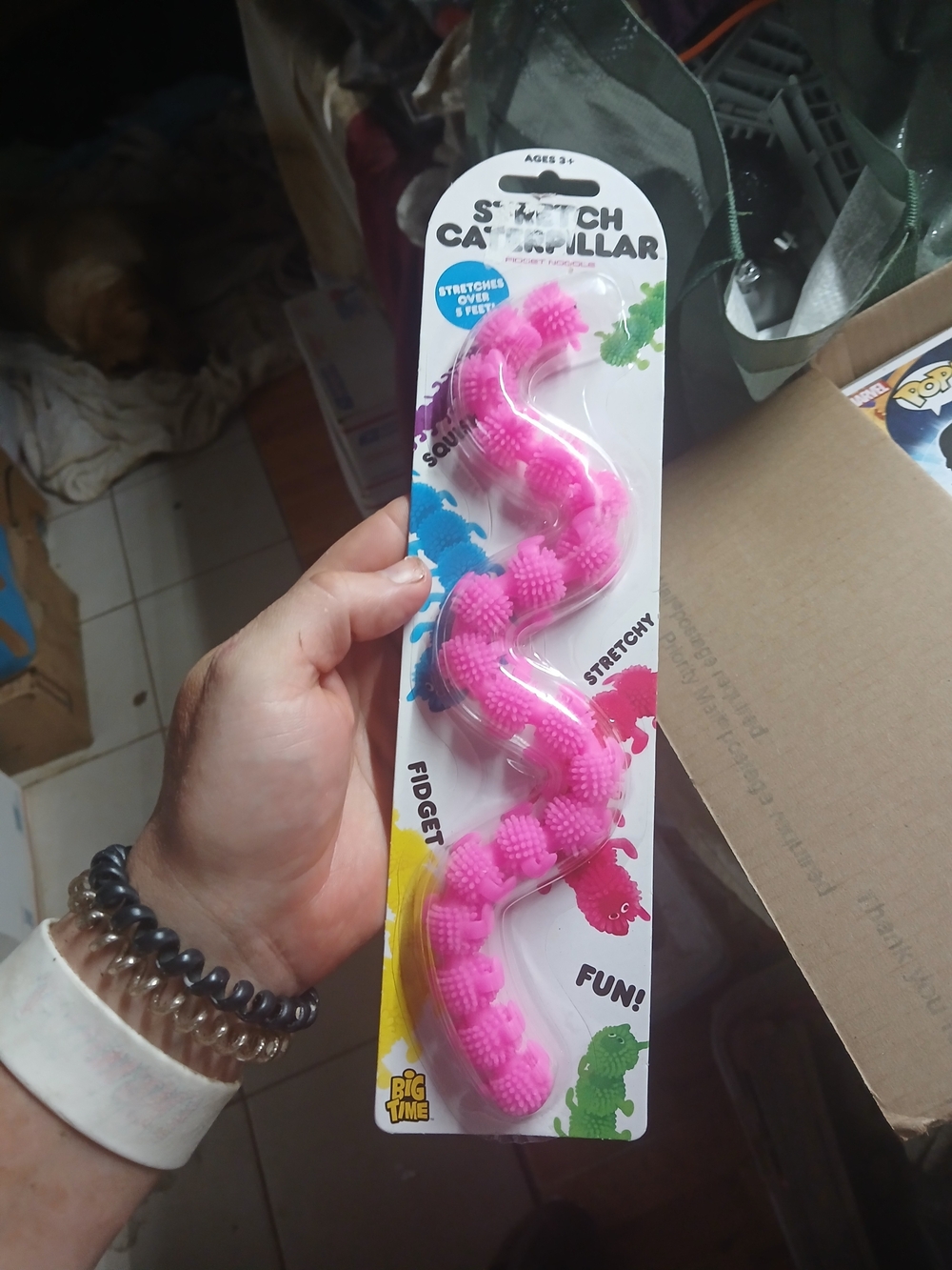 a pink stretchy caterpillar fidget toy with bumpy textures, made by Big Time Toy